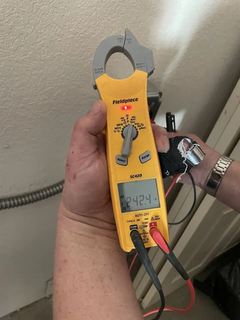 Voltage testing with clamp meter during Ceiling Fan Installation in Cottage Grove